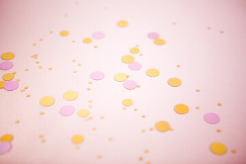 Pink festive background with glittering confetti decoration and bokeh