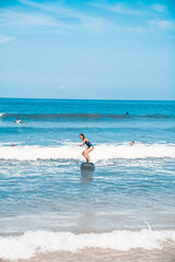 Surfing. A surfer on the waves in the ocean off the coast of Asia on the island of Bali in Indonesia. Sports and extreme. Beauty and health. Fashion and beach style.