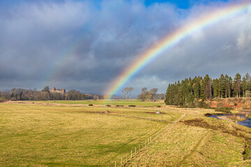 A rainbow over Thirlestane Castle beside Leader Water at Lauder, Scottish Borders, Scotland UK
