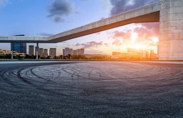 Asphalt road and city skyline with modern buildings at sunset in Ningbo, Zhejiang Province, China. - obrazy, fototapety, plakaty