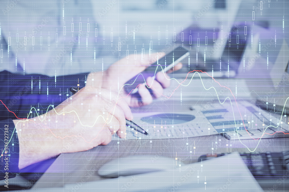 Poster double exposure of man's hands holding and using a digital device and forex graph drawing. financial