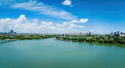 Fototapeta premium Aerial view of city skyline and modern buildings with lake scenery in Suzhou, China.