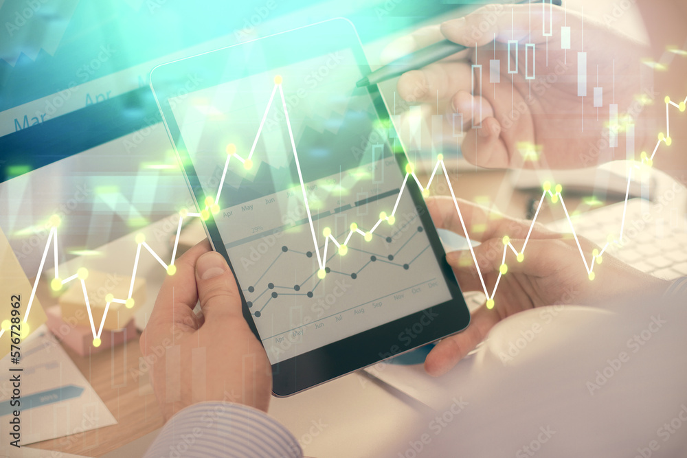 Poster double exposure of man's hands holding and using a phone and financial chart drawing. market analysi