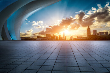 Empty square floor and city skyline with modern buildings at sunset in Ningbo, Zhejiang Province, China. 