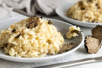 Risotto with porcini mushrooms and black truffles served in a plate top view, gourmet cousine