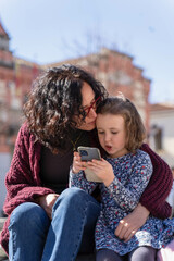 Mother and daughter enjoy watching photos on he sparphone