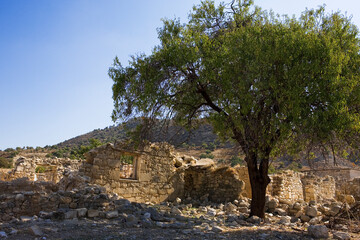 Fototapeta na wymiar The Turkish Cypriot village of Souskiou in the Dhiarizos valley, Paphos District, abandoned during the civil war in 1974: ruined dwellings in an ex-Turkish enclave in Greek Cyprus