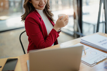 Portrait of a business woman talking on the phone and drinking coffee