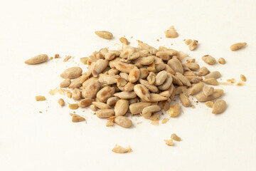 Toasted sunflower seeds on white background. Selective focus.