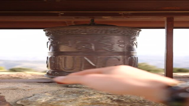 Meditative Movements: A Hand Turning a Buddhist Mani Wheel