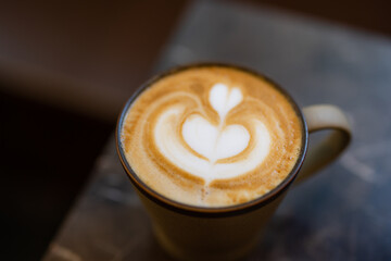 Delicious latte with creative milk froth pattern