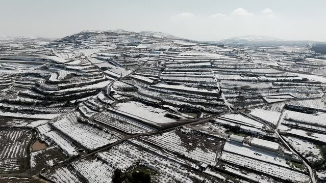 Agriculture terrace fields covered with fresh white snow, Aerial view