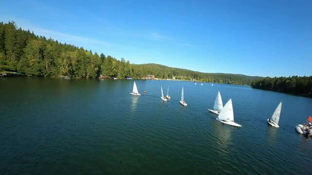dynamic aerial fpv shots of sailing boats at the lake packer stausee in styria, austria