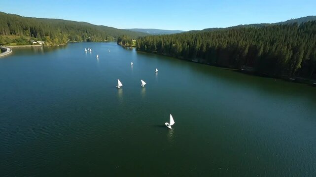 dynamic aerial fpv shots of sailing boats at the lake packer stausee in styria, austria