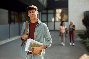 Portrait of male college student at campus looking at camera. - obrazy, fototapety, plakaty