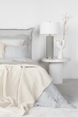 Fototapeta na wymiar Elegant lamp and decorative vase on bedside table