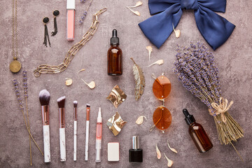 Fototapeta na wymiar Dropper bottles, make up brushes, sunglasses, jewelry, cosmetics and lavender bouquet flat lay.