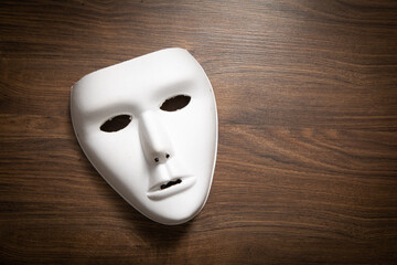 White mask on the wooden table.