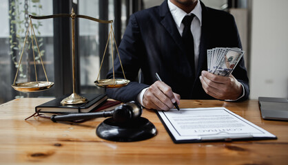 lawyer working with contract agreement at table office, lawyer holding money and justice concept, Selective focus.