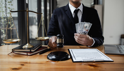 lawyer working with contract agreement at table office, lawyer holding money and justice concept, Selective focus.