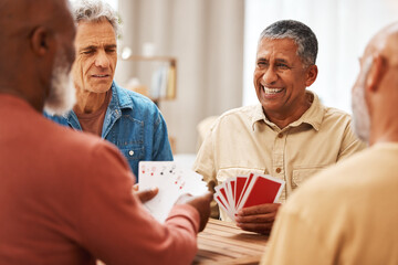 Senior man, friends and playing card games on wooden table in fun activity, social bonding or...