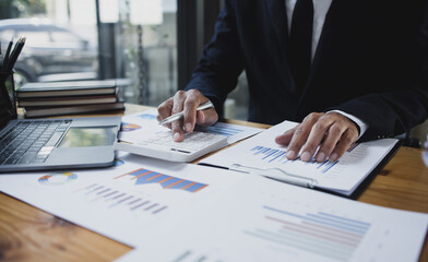 Businessman hands working with market report document and management business project, Business accounting concept.