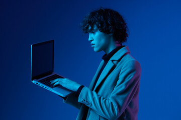 man with a laptop in his hands and a jacket, smile, glasses in blue light, Blue Perennial color,...
