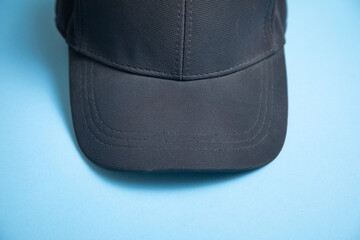 Baseball cap on the blue background.