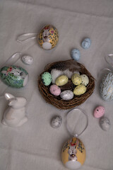 Fototapeta na wymiar photo on a white Easter tablecloth multicolored decorative toys