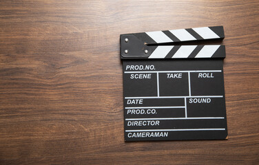 Movie clapper on the wooden background.