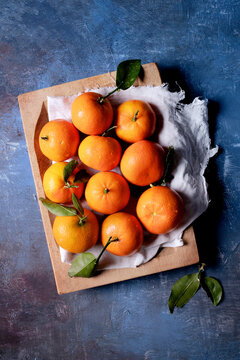 Clementine, mandarin, tangerine fruit, on blue background.