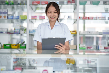 Fototapeta na wymiar Asian woman pharmacist working at Pharmacy Drugstore . Medical healthcare concept