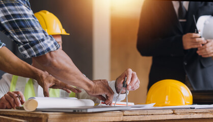 Two business man construction site engineer. Engineering objects on workplace with partners interacting on background