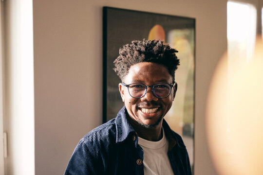 Portrait of cheerful man wearing eyeglasses at home