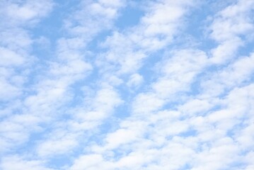 Obraz premium White fluffy clouds with blue sky and sun light for background texture 