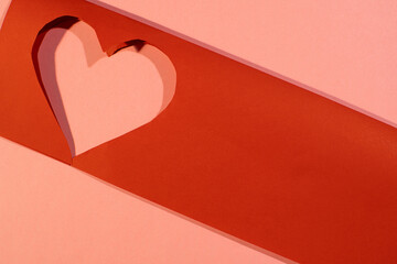 Heart symbol cut out of red paper, paper valentine