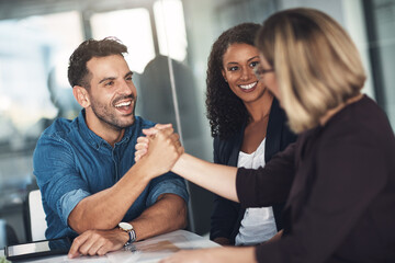 Strong partners make a strong business relationship. Shot of a businesswoman and businessman shaking hands during a meeting in a modern office.