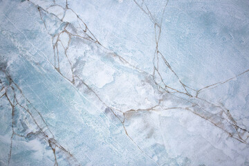 Blue background of decorative plaster with abstract spots. Unusual texture of this wall with beautiful patterns, creative surface background. Finishing coating for building cladding.