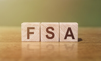 FSA - an abbreviation of wooden blocks with letters. Reflection caption on the mirrored surface of...