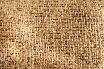 Detailed natural burlap background. The texture of the fabric of a brown coarse belt. Close-up