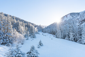 People enjoying the landscape with bright sun in the snow doing outdoor sport in winter, skiing in a ski resort on holiday. Lifestyle