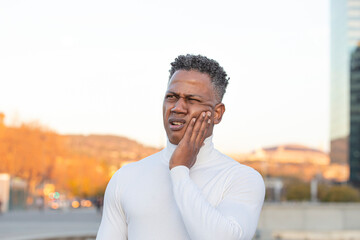 Black-skinned man in profile complaining of toothache