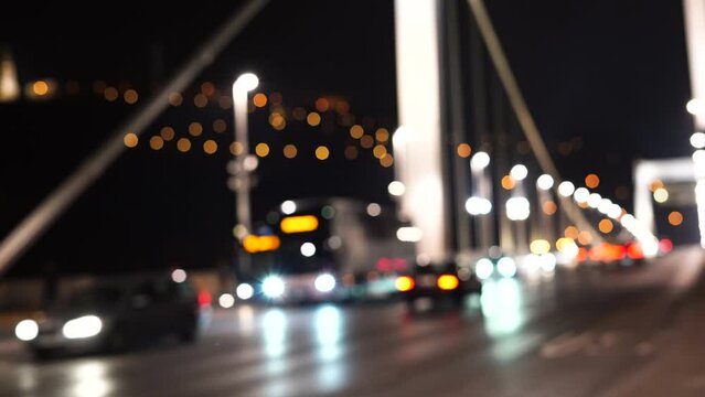 Defocused road traffic transport On Bridge, city night. Blurred lights bokeh car headlights driving evening city road. Background city street night