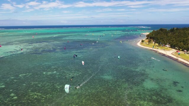 Aerial view people doing kite surf along the beach near Le Morne Brabant mountain, Mauritius island.