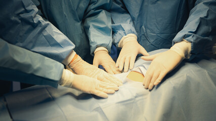 The medical team combines hands to unite their energy to make this work successful..