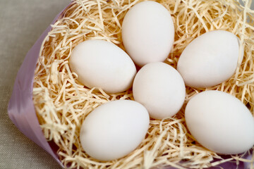 Eggs duck on background and hay