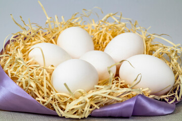 Eggs duck on background and hay