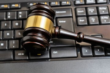 Obraz na płótnie Canvas Cyber law or justice concept, judge gavel on computer keyboard