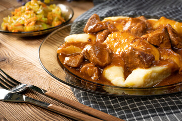 Beef stew in gravy, served with potato dumplings.