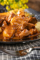 Beef stew in gravy, served with potato dumplings.